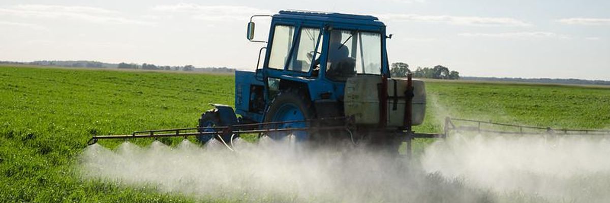 A farmer applies pesticides to their field 