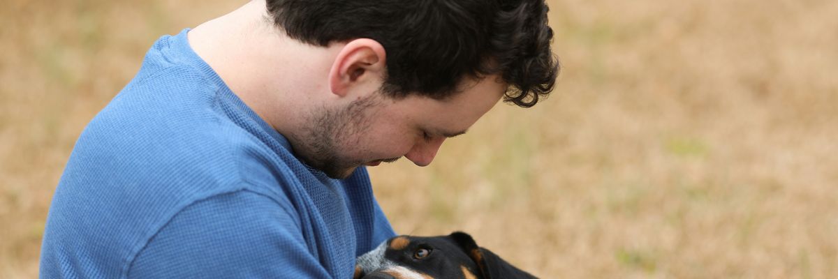 A man hugs his dog 