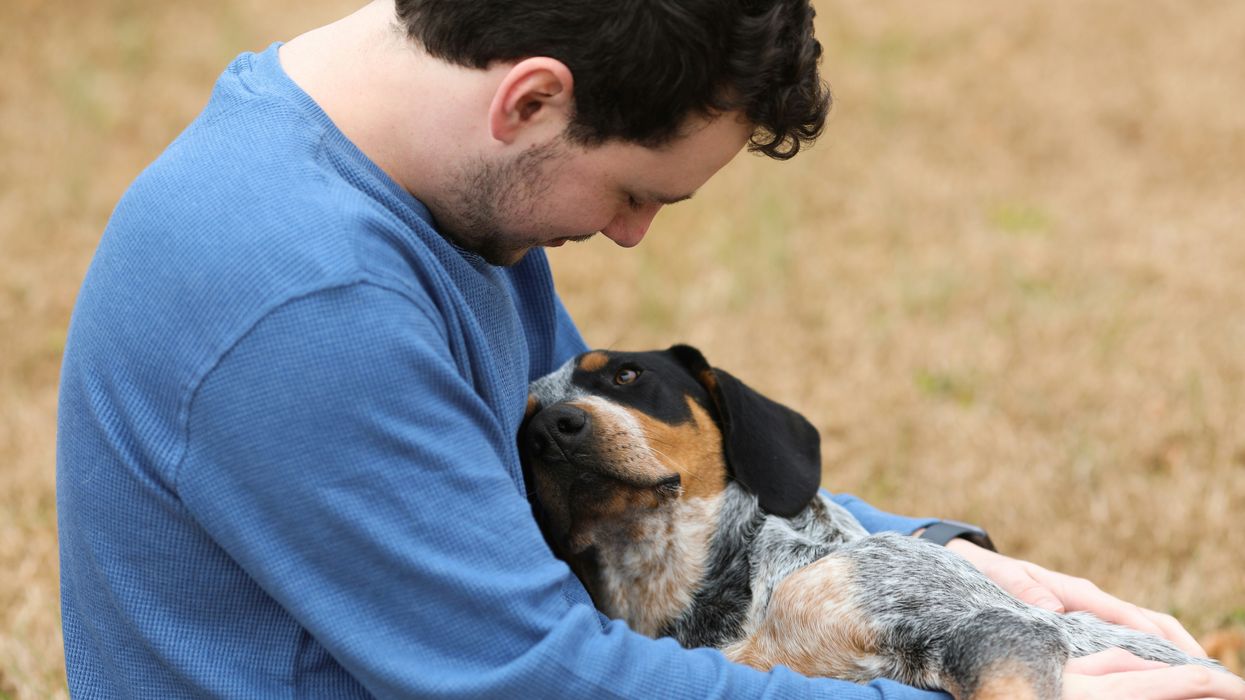 A man hugs his dog 